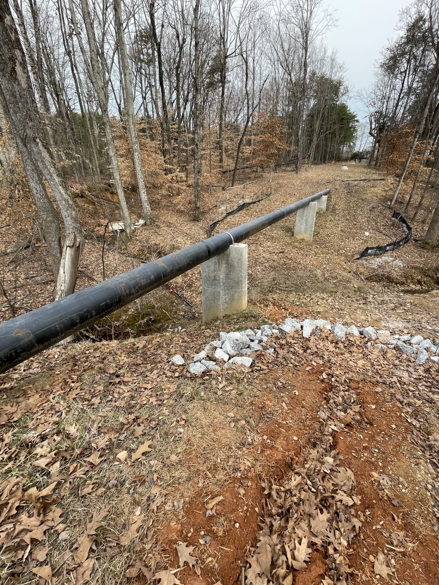 Aerial sewer crossing installation for land development utility infrastructure — Hagen Engineering