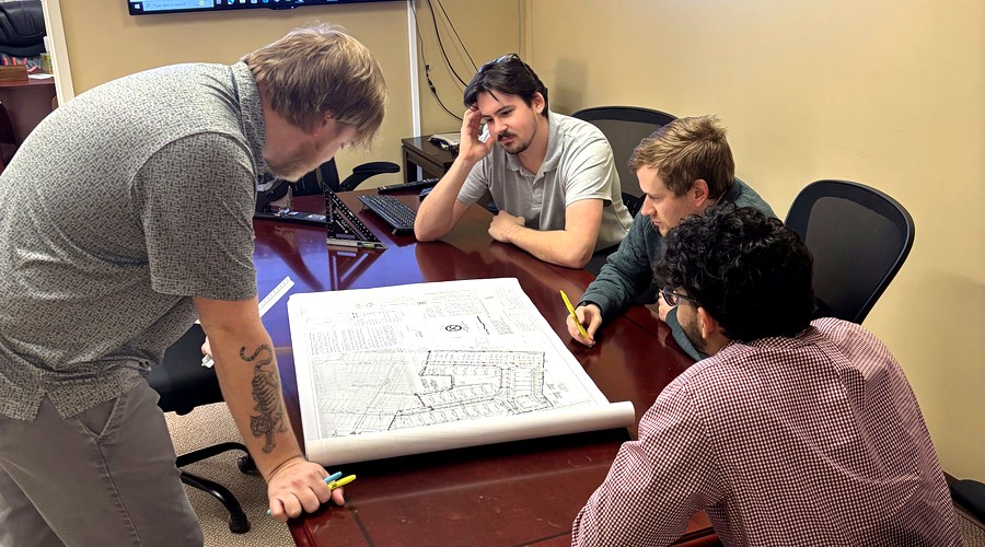 Hagen Engineering team reviewing civil engineering plans in office