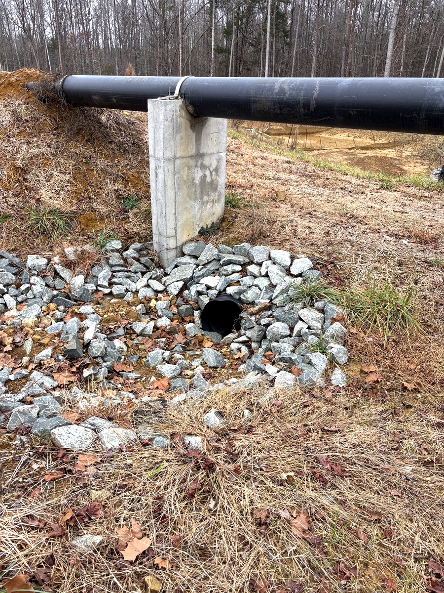 Stormwater pipe outlet with riprap — civil drainage infrastructure